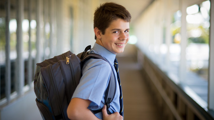 Bailey standing with his backpack