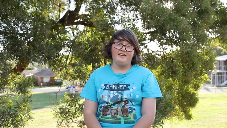 a girl wearing glasses and wearing a blue t shirt