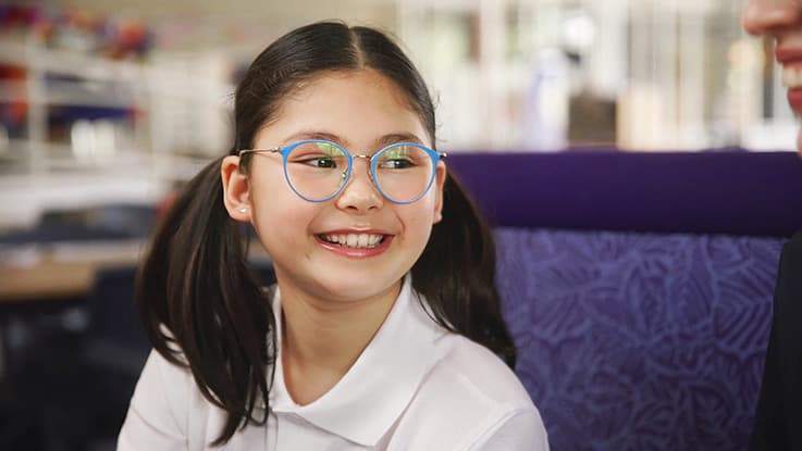 Girl in library wearing glasses Broll