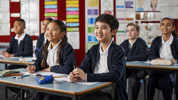 students in a classroom smiling